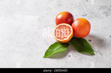 Juicy sicilian red oranges on a gray concrete background. Top view and copy space. Stock Photo