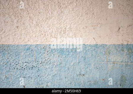 Fragment of a blue-white painted peeled dirty wall Stock Photo