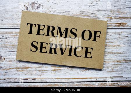 Terms of Service written on paper card top view of wooden background Stock Photo