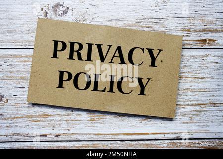 Privacy Policy written on paper card top view of wooden background Stock Photo