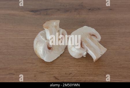 White champignon cut in half. Fresh vegetables on the table. Stock Photo
