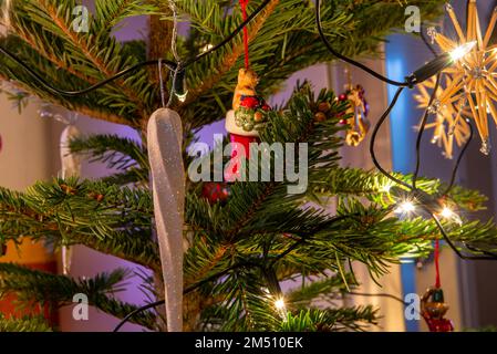 Close up of ornaments hanging from a christmas tree Stock Photo