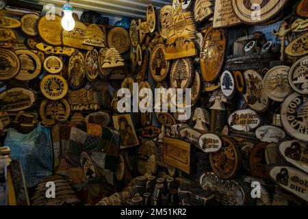 A closeup shot of handmade wooden home decorations reading 'God bless our home' in a market Stock Photo