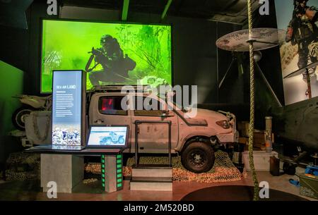 Interior of Navy SEAL museum in Fort Pierce showing an all terrain vehicle and a video of the soldier with a pointed weapon. Stock Photo