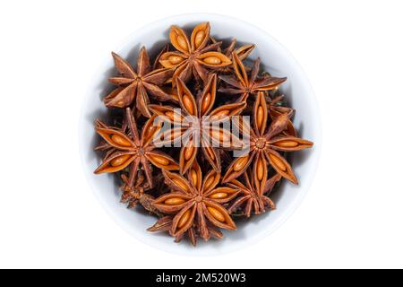 Star anise star-anise Christmas spice herb from above bowl isolated on a white background Stock Photo