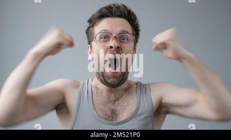 Overjoyed mature man raising fists up. Achievement or win in lottery. Stock Photo