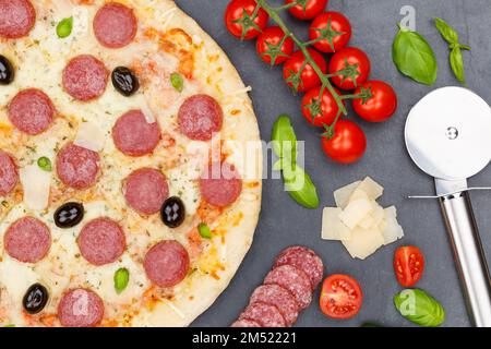 Pizza pepperoni salami from above baking ingredients close up on a slate Stock Photo
