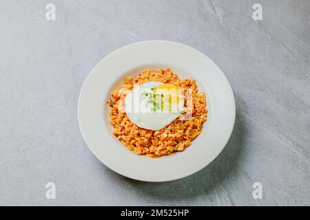 Kimchibokkeumbap, Korean Kimchi Fried Rice : Rice fried with finely chopped kimchi. Beef, pork, onions, green onions, and other vegetables may be adde Stock Photo