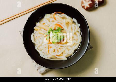 Kalguksu, Korean style noodle soup :Fresh knife-cut noodles, made by rolling flour dough and slicing into thin noodles, cooked in anchovy sauce. Zucch Stock Photo