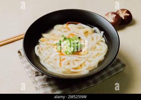 Kalguksu, Korean style noodle soup :Fresh knife-cut noodles, made by rolling flour dough and slicing into thin noodles, cooked in anchovy sauce. Zucch Stock Photo