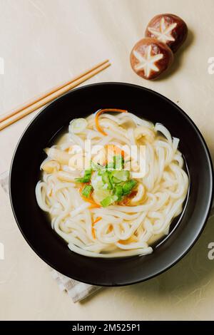 Kalguksu, Korean style noodle soup :Fresh knife-cut noodles, made by rolling flour dough and slicing into thin noodles, cooked in anchovy sauce. Zucch Stock Photo