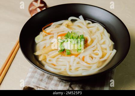 Kalguksu, Korean style noodle soup :Fresh knife-cut noodles, made by rolling flour dough and slicing into thin noodles, cooked in anchovy sauce. Zucch Stock Photo