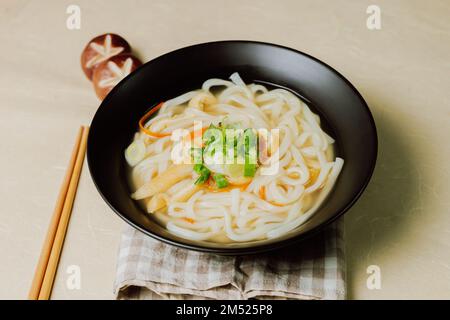 Kalguksu, Korean style noodle soup :Fresh knife-cut noodles, made by rolling flour dough and slicing into thin noodles, cooked in anchovy sauce. Zucch Stock Photo