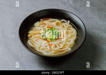 Kalguksu, Korean style noodle soup :Fresh knife-cut noodles, made by rolling flour dough and slicing into thin noodles, cooked in anchovy sauce. Zucch Stock Photo