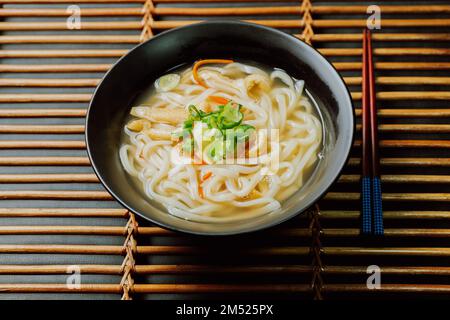 Kalguksu, Korean style noodle soup :Fresh knife-cut noodles, made by rolling flour dough and slicing into thin noodles, cooked in anchovy sauce. Zucch Stock Photo