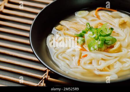 Kalguksu, Korean style noodle soup :Fresh knife-cut noodles, made by rolling flour dough and slicing into thin noodles, cooked in anchovy sauce. Zucch Stock Photo