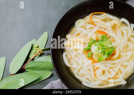 Kalguksu, Korean style noodle soup :Fresh knife-cut noodles, made by rolling flour dough and slicing into thin noodles, cooked in anchovy sauce. Zucch Stock Photo