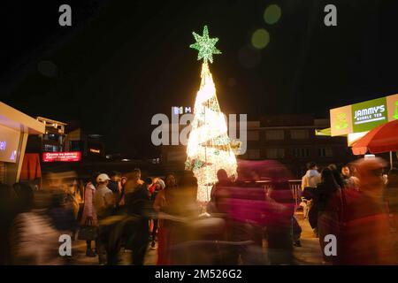 Lalitpur, Nepal. 24th Dec, 2022. People admire Christmas lights and decorations during Christmas eve at the shopping mall in Lalitpur. Christmas Eve is the evening or entire day before Christmas Day, the festival commemorating the birth of Jesus Christ. Christmas Day is observed all-around the world. (Photo by Prabin Ranabhat/SOPA Images/Sipa USA) Credit: Sipa USA/Alamy Live News Stock Photo