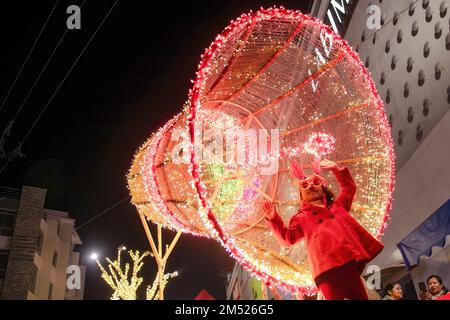 Lalitpur, Nepal. 24th Dec, 2022. A girl poses for photos in front of the Christmas decorations during Christmas Eve at the Lalitpur shopping center. Christmas Eve is the evening or entire day before Christmas Day, the festival commemorating the birth of Jesus Christ. Christmas Day is observed all-around the world. (Photo by Prabin Ranabhat/SOPA Images/Sipa USA) Credit: Sipa USA/Alamy Live News Stock Photo