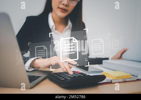 Businesswoman working on Document Management System (DMS). Software for archiving, searching, and managing corporate files and information, documentat Stock Photo