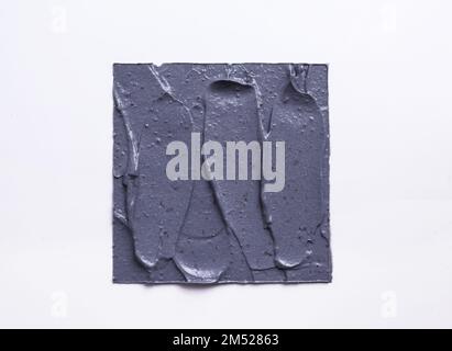 A charcoal clay texture swatch on white background Stock Photo