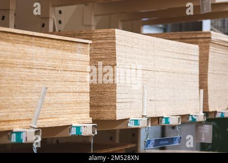 OSB boards in stock, chipboard stacked on pallets in building materials and supplies store, Moscow, Dec 2022 Stock Photo