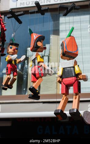 Wooden pinocchio dolls with long nose. Conceptual fairy tale character Stock Photo