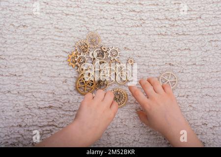 Hand holding gear wheels as the concept of mechanism Stock Photo