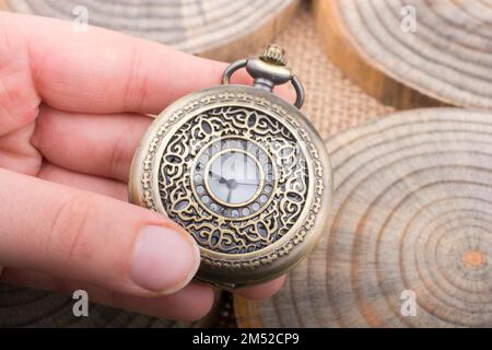 Mechanical pocket watch on pieces of wood Stock Photo