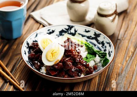 Taiwanese Braised Meat Pork Over Steamed White Rice with Boiled Egg and Pak Choi or Bok Choy. Chinese Traditional Dish Stock Photo