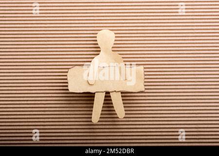 Paper man shape holding burnt note paper in hand Stock Photo