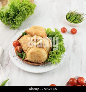 Kue Pastel or Jalangkote, Karipap Pusing. Asian Typical Snack made from Fried Pastry with Carrot, Potato, and Boiled Egg FIlling Stock Photo