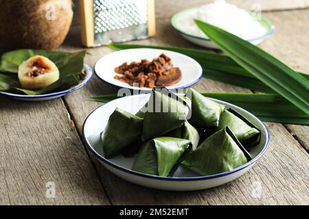 Sweet Stuffed Dough Pyramid Dumpling or Kanom Tian or  Khanom Tien. Wrapped with Banana Leaf.  Thai Traditional Dessert Stock Photo