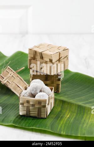 Peanut Mochi, Japanese Popular Dessert, on White Table with Bamboo Go Green Packaging Stock Photo