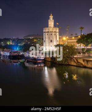 Golden tower Torre del Oro watchtower along the Guadalquivir river at night in Seville, Andalusia, Spain on 7 December 2022 Stock Photo