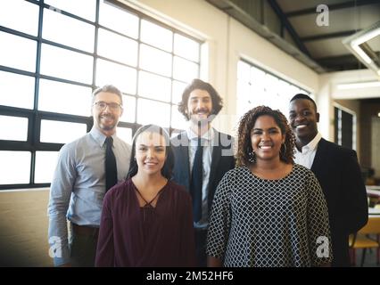 Were ready to be your dream team. Portrait of a diverse team of happy businesspeople posing together in their office. Stock Photo