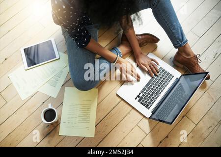 Checking all the business stats. High angle shot of a young female designer working in her office. Stock Photo