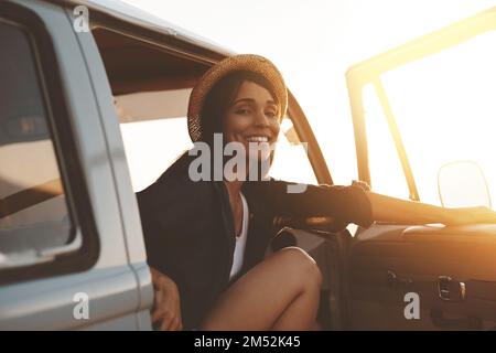 You had me at road trip. an attractive young woman enjoying a road trip. Stock Photo