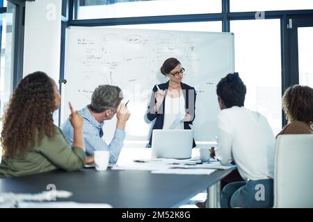 Step by step to success. a group of focussed businesspeople attending a colleagues presentation in the boardroom. Stock Photo