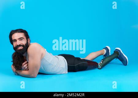 Relaxed man with a prosthetic leg lying on the floor Stock Photo