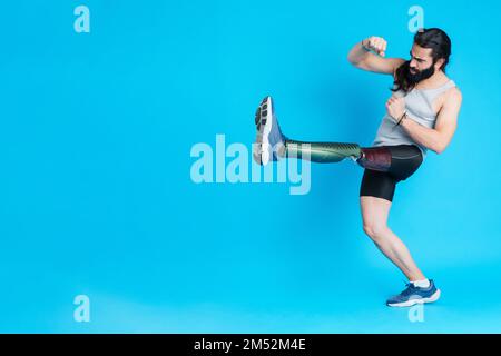 Man with a prosthesis on his leg kicking and fighting Stock Photo