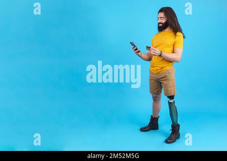 Studio portrait of a man with prosthesis on his leg Stock Photo