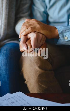 Held in the strength and support of each other. Closeup shot of a couple holding hands in comfort. Stock Photo