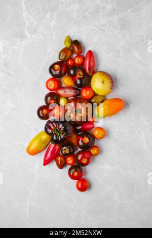 Vertical composition with various types of tomatoes Stock Photo