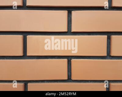 fragment of a wall with a red facing brick Stock Photo