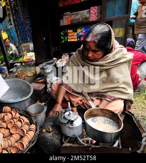 A Bengali woman preparing traditional Indian milk tea in Kolkata, India. Stock Photo