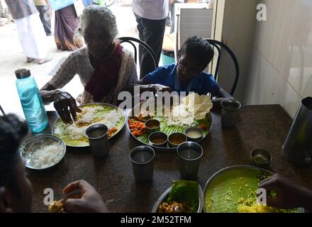 A traditional South Indian Thali meal served on a banana leaf in a restaurant in Madurai, Tamil Nadu, India. Stock Photo