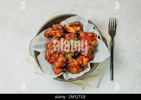 yangnyeom chicken, Korean style Seasoned Fried Chicken : This dish is seasoned chicken cut into pieces, deep- fried, and mixed with soy sauce, gochuja Stock Photo