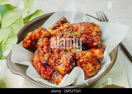 yangnyeom chicken, Korean style Seasoned Fried Chicken : This dish is seasoned chicken cut into pieces, deep- fried, and mixed with soy sauce, gochuja Stock Photo