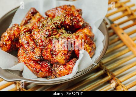 yangnyeom chicken, Korean style Seasoned Fried Chicken : This dish is seasoned chicken cut into pieces, deep- fried, and mixed with soy sauce, gochuja Stock Photo